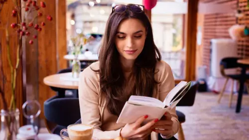 A beautiful woman focused reading his book in a coffee shop